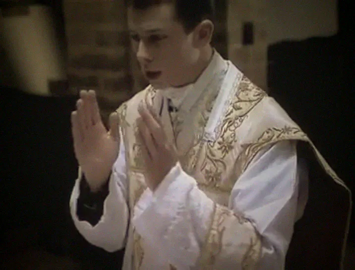 The priest extends his hands as he begins the Gloria.