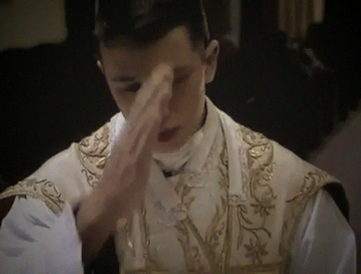 The priest signs his forehead with the cross at the Gospel.