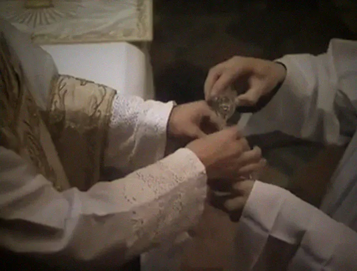 Water is poured over the priest's fingers at the Lavabo.