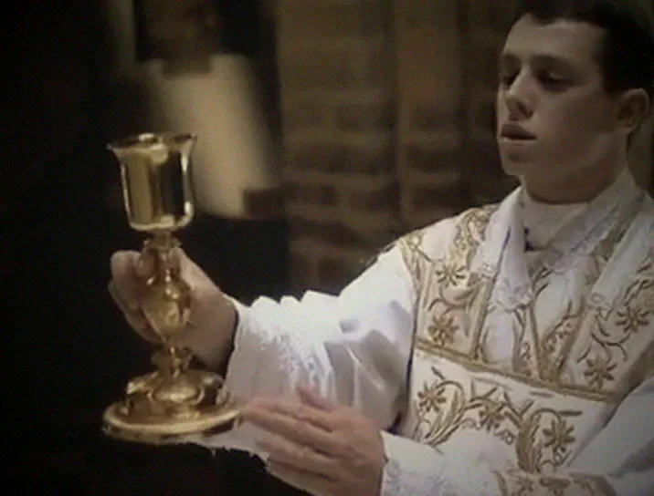 The priest raises the chalice at the Offertory.